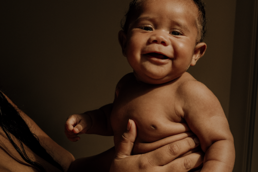 Baby facing forward and smiling